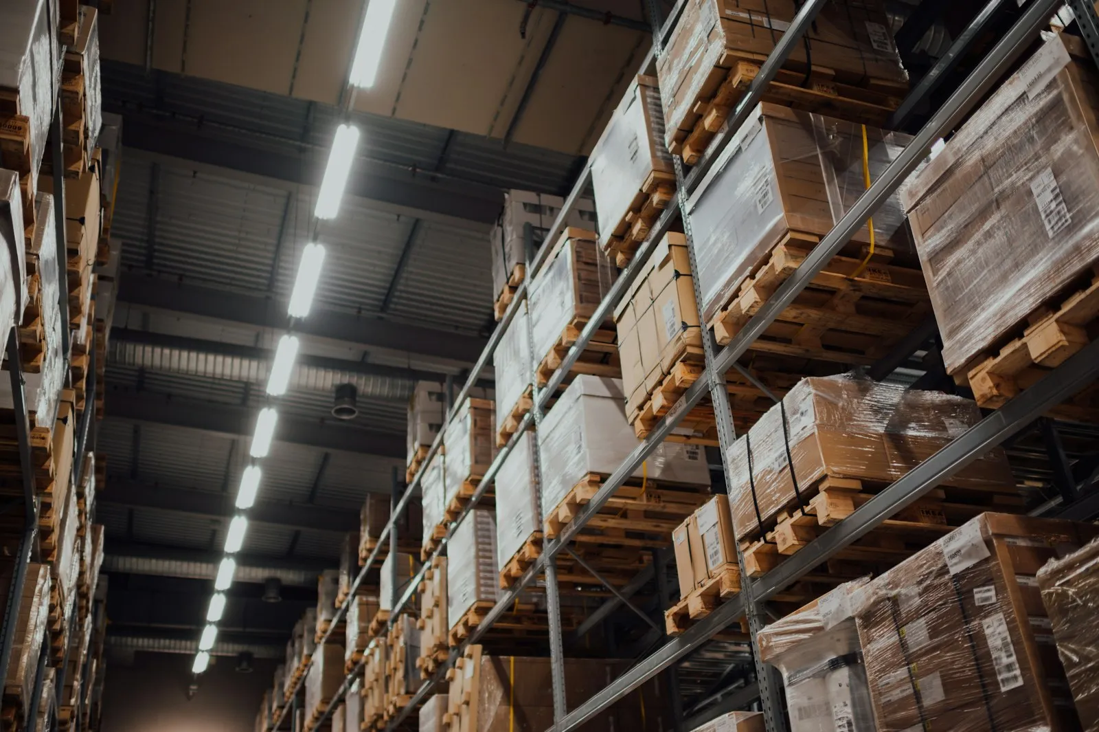 Boxed stock on warehouse racking under overhead lights